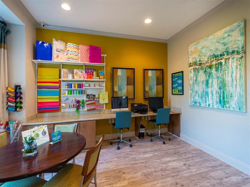 a home office with two computers and a table