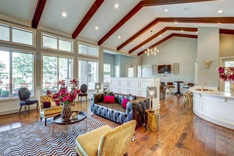 a living room with large windows and a couch