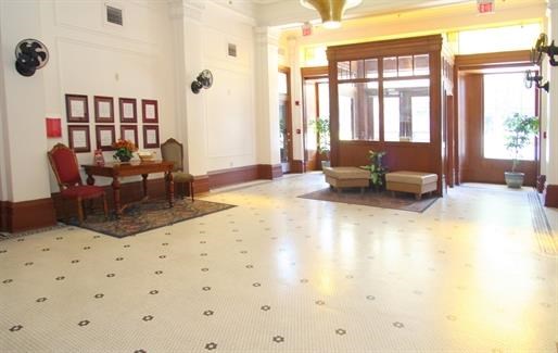a lobby of a building with a table and chairs