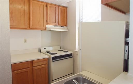 a kitchen with a stove and a refrigerator