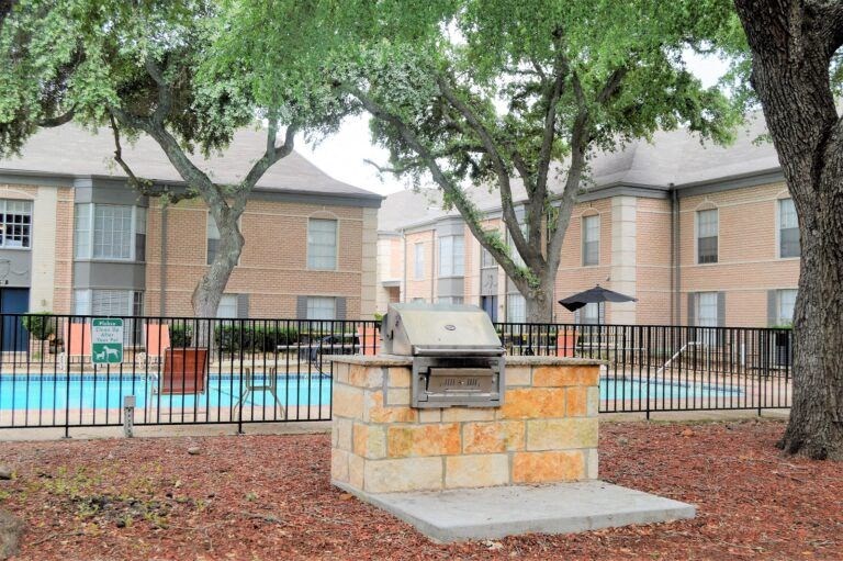 a grill in front of an apartment building