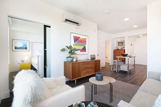 a living room with white walls and a white couch