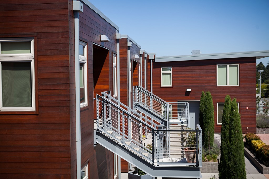 a row of houses with balconies and railings