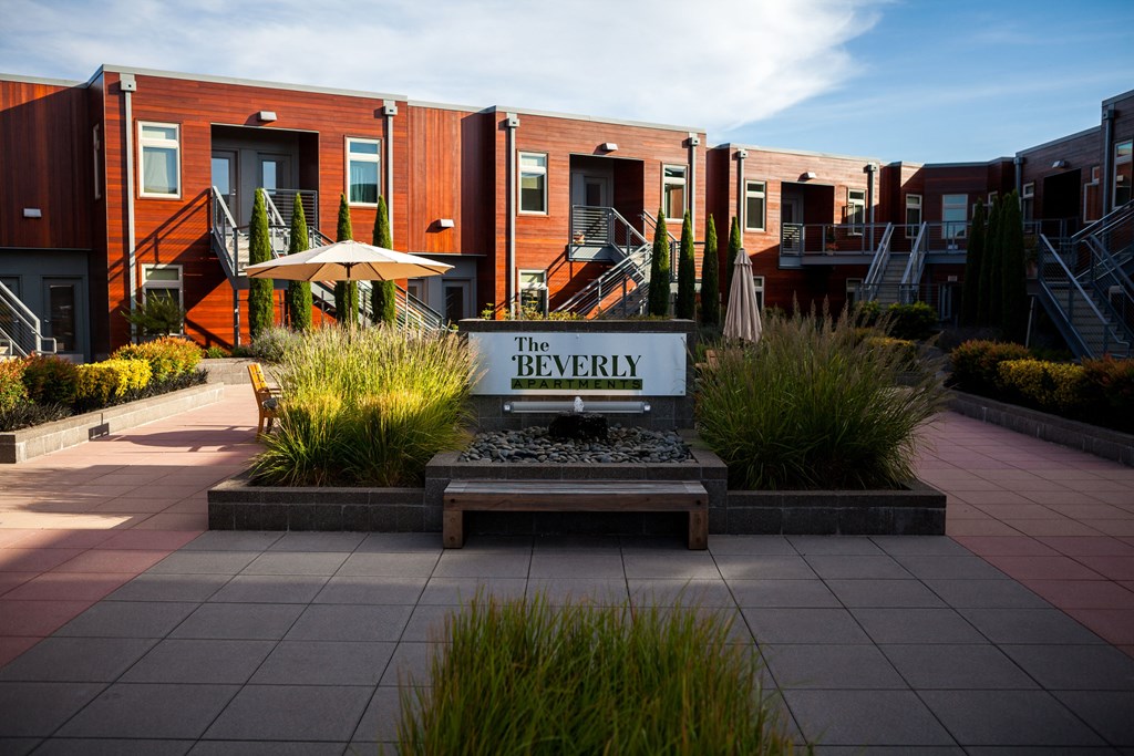 an outdoor area with a bench and a sign that reads the library