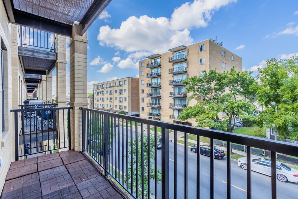 a balcony with a view of a building and a street
