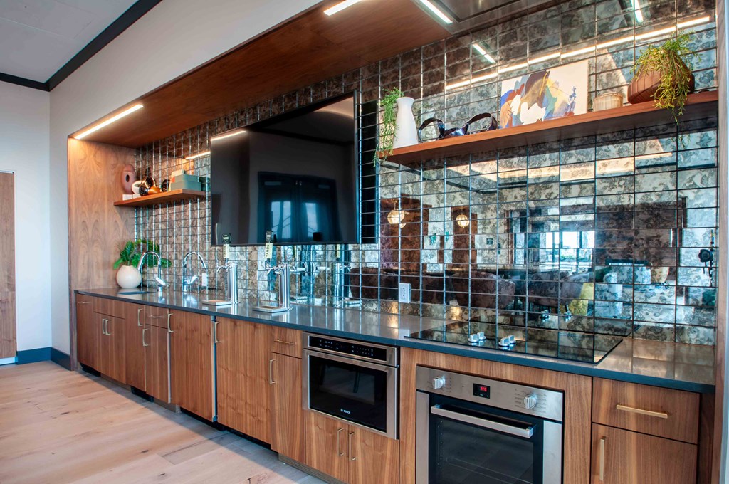 a kitchen with wooden cabinets and stainless steel counter tops