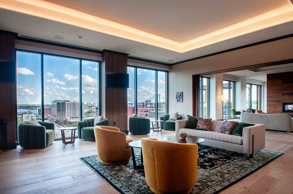 a living room filled with furniture and a view of a city