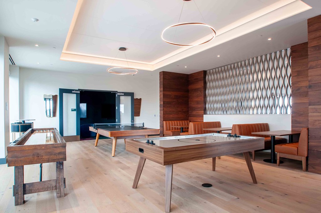 a billiards room with tables and chairs