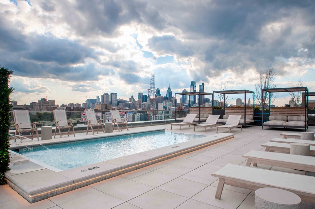 a rooftop pool with a view of the city
