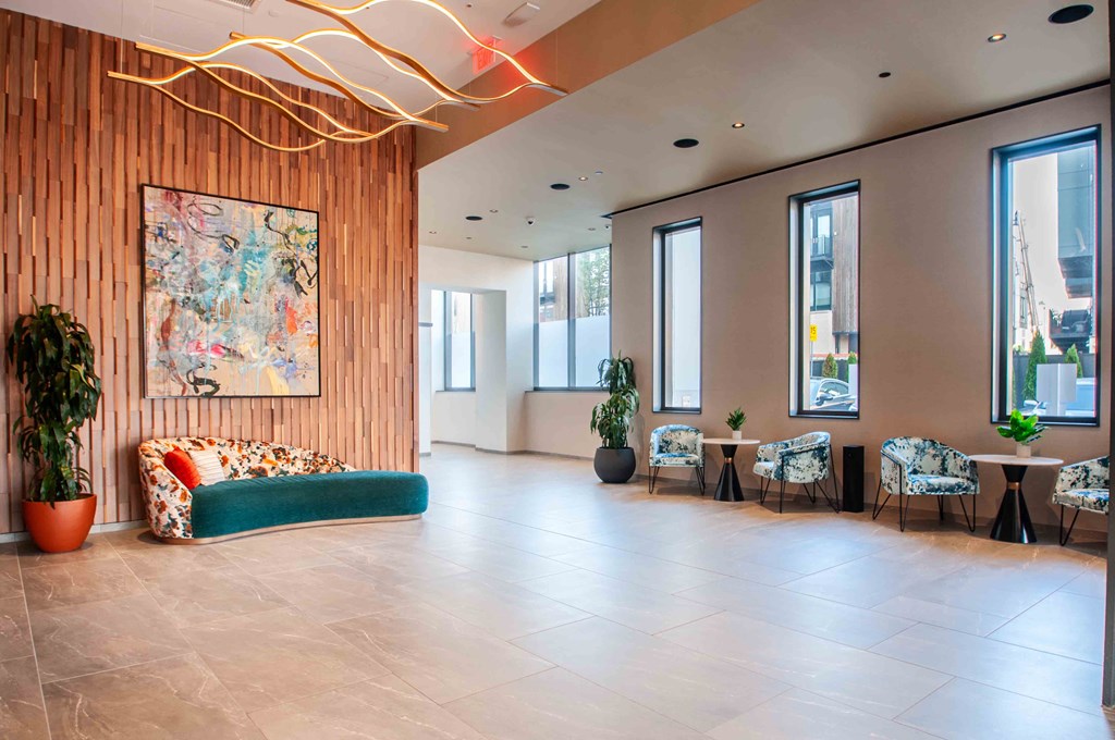 a large lobby with a couch and tables and windows