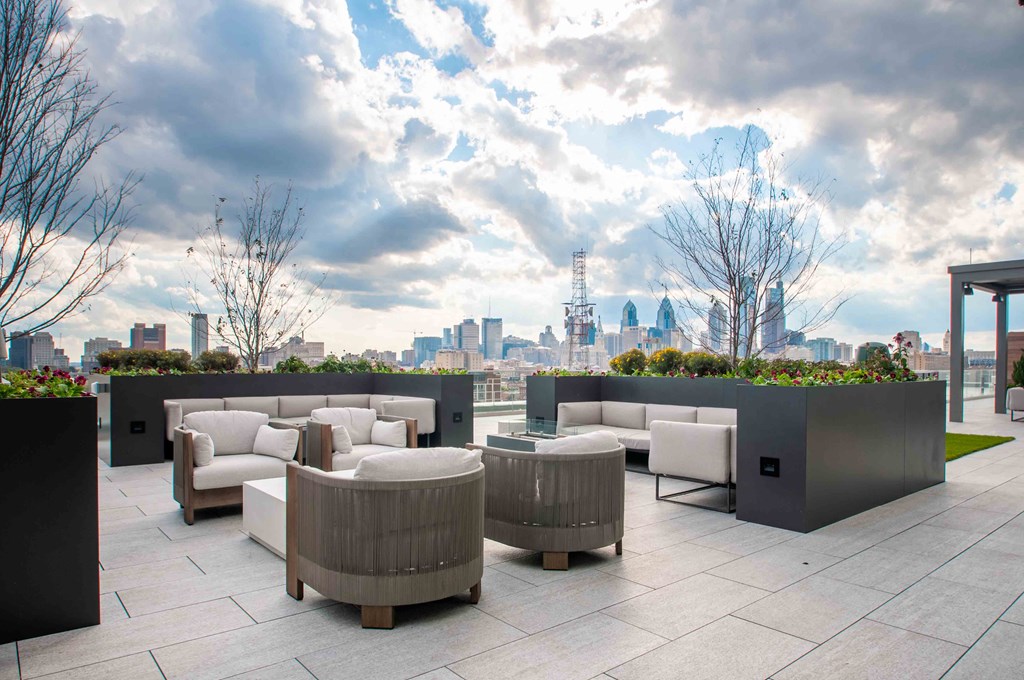 a roof terrace with a view of the city