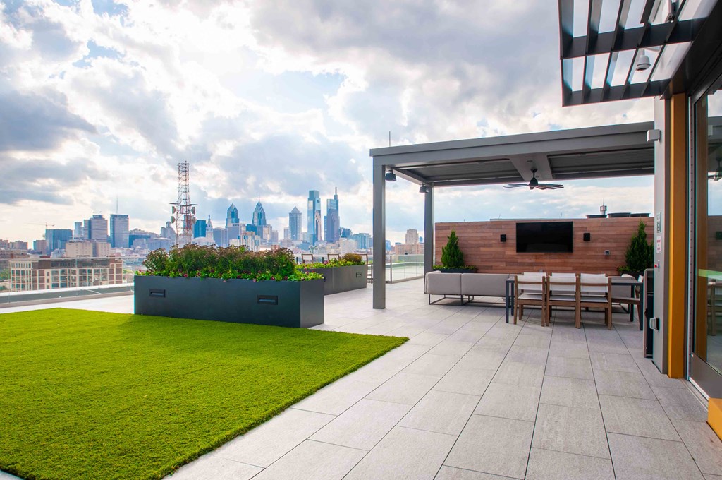 a roof top terrace with a view of the city