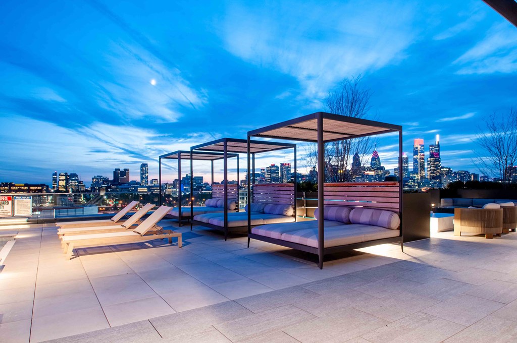 a rooftop lounge with a view of the city