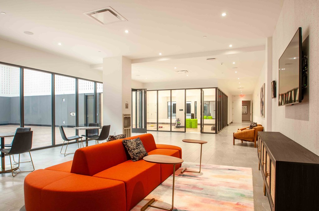 a living room with an orange couch and a table
