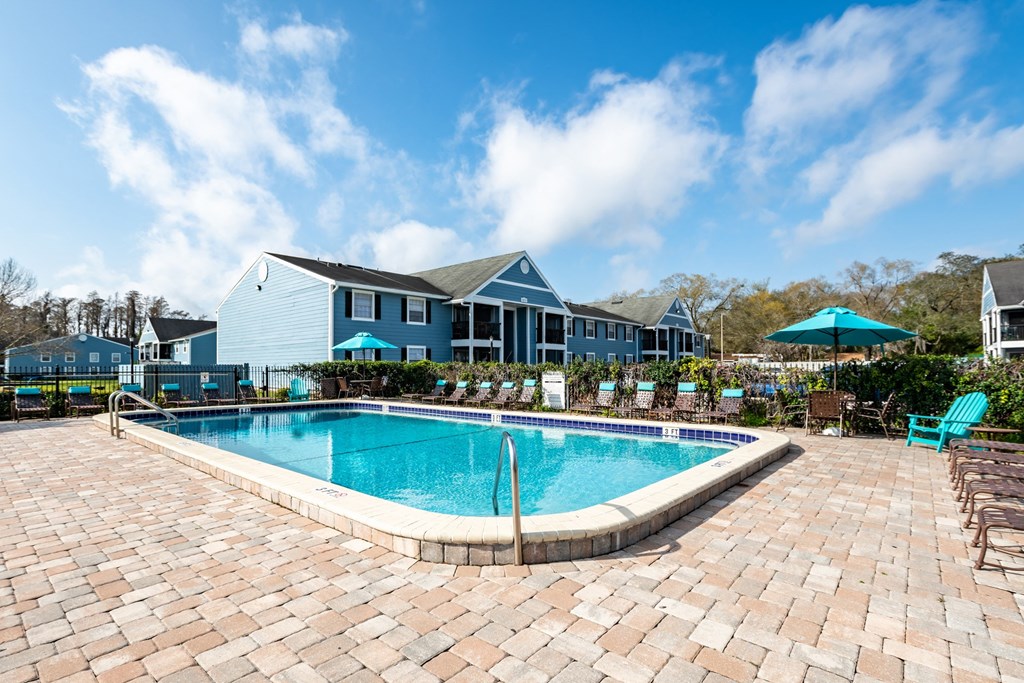 Pool with lounge chairs at The Commons apartments in Tampa, FL near downtown Tampa.