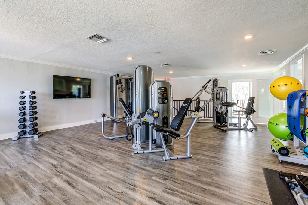Equipped fitness center inside The Commons apartment community in Tampa, Florida.