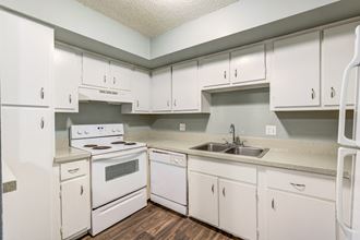 The Commons Apartments in Tampa Florida photo of a kitchen with white cabinets and white appliances