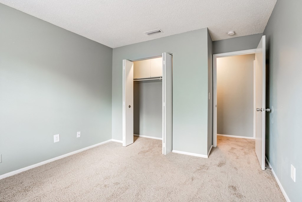 Bedroom with a large closet at The Commons, a pet-friendly community in Tampa, FL, near Temple Terrace.