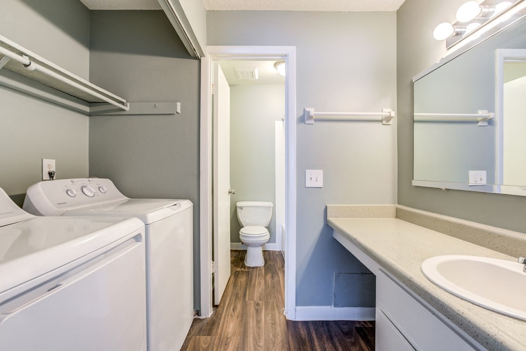 Stacked washer and dryer inside an apartment laundry closet at The Commons, Tampa, Florida.