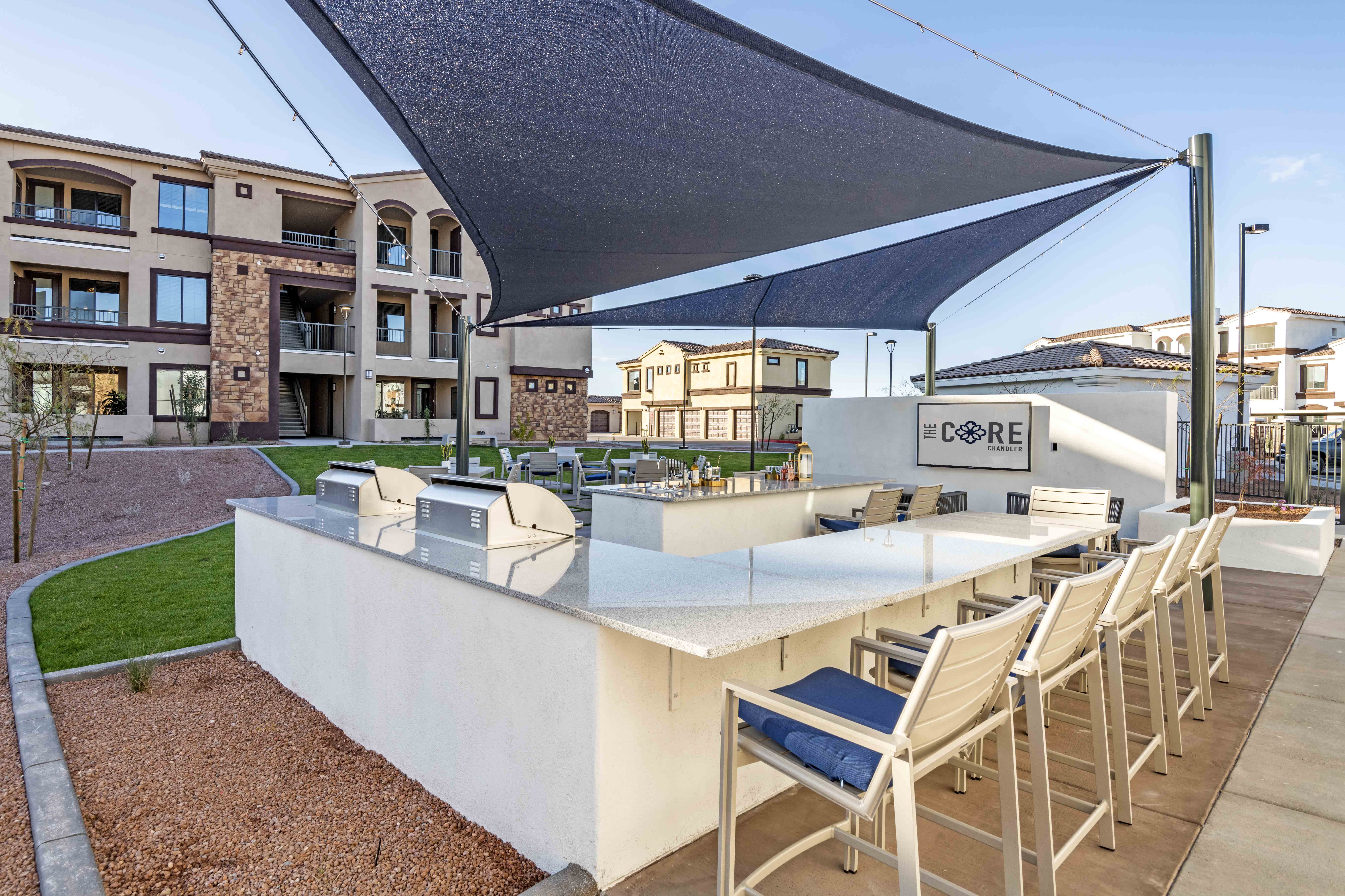 Apartments for Rent in Chandler - The Core Chandler - Grill Area with BBQ Station, Bar Chairs, and Quartz Dining Counters