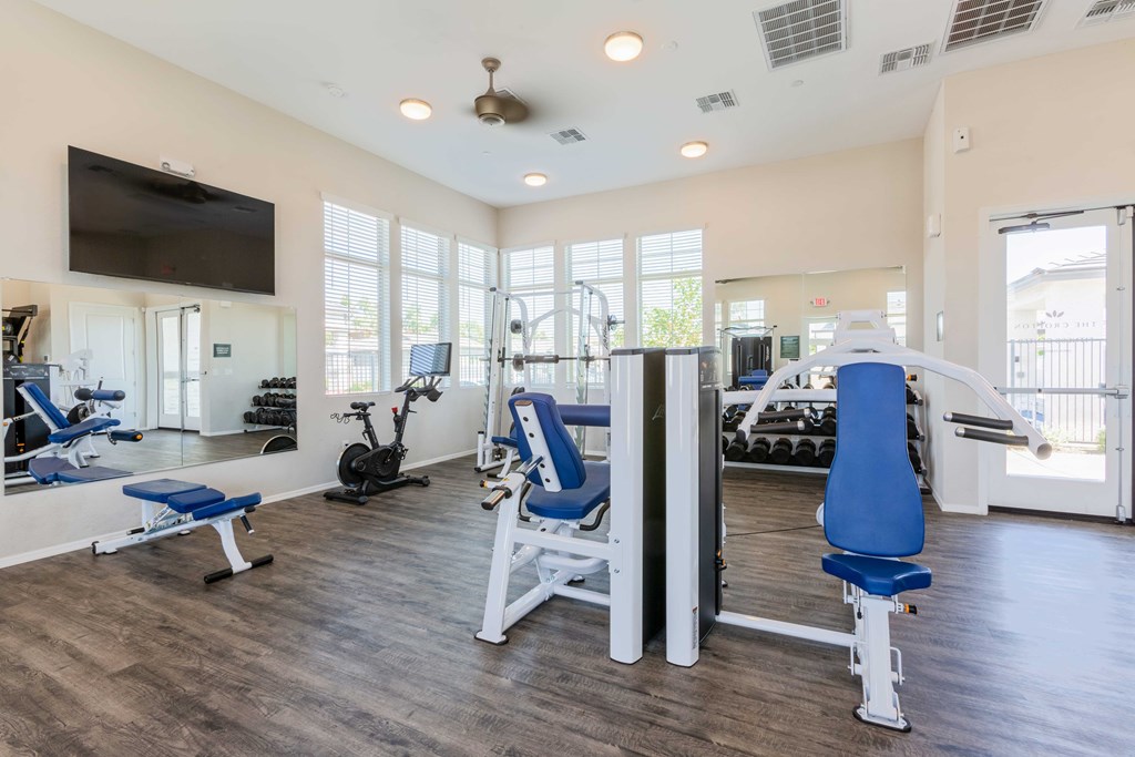 A spacious home gym with a variety of exercise equipment.