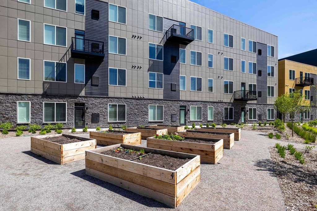 a community garden in front of an apartment building