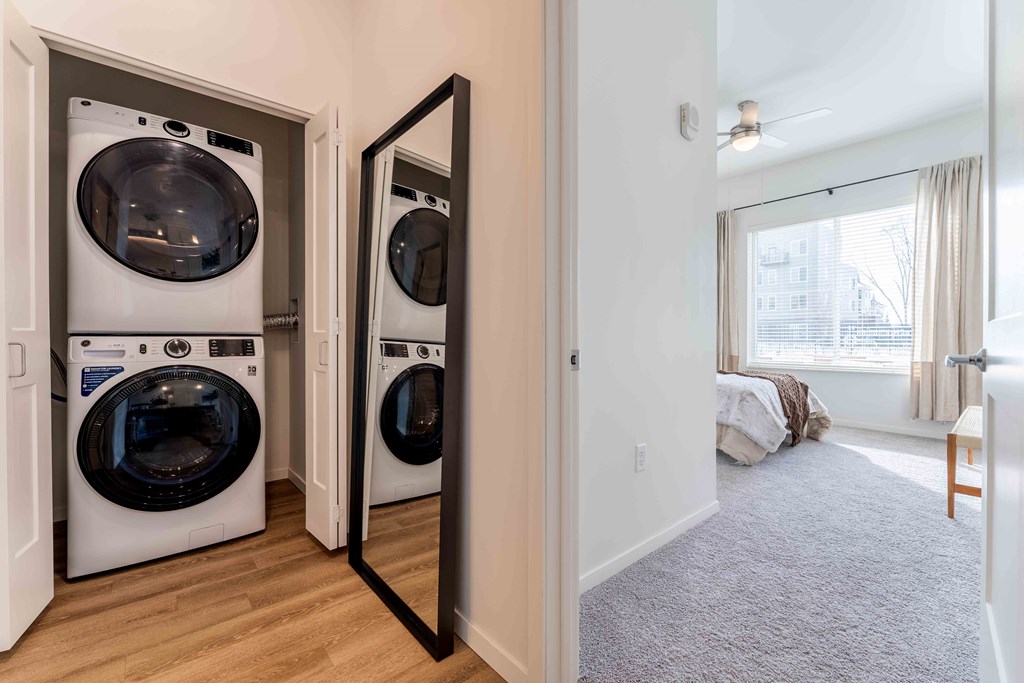 a washer and dryer in a laundry room with a mirror