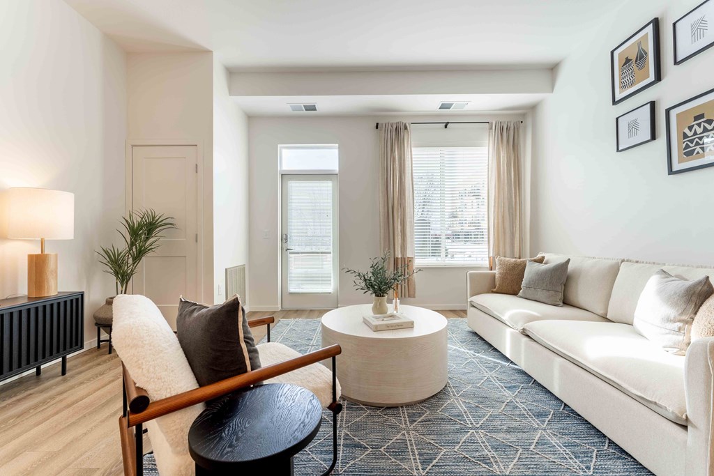 a living room with white couches and a coffee table