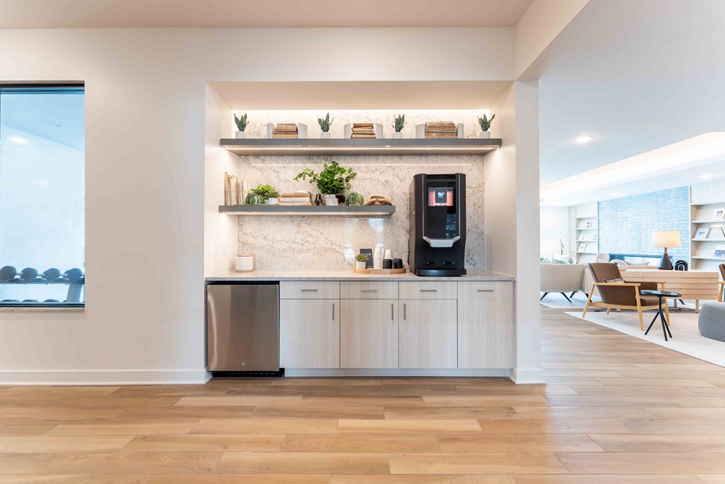 a kitchen with white cabinets and a coffee machine