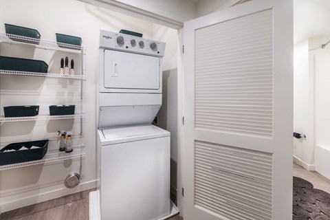 A white oven and dishwasher are in a small kitchen.