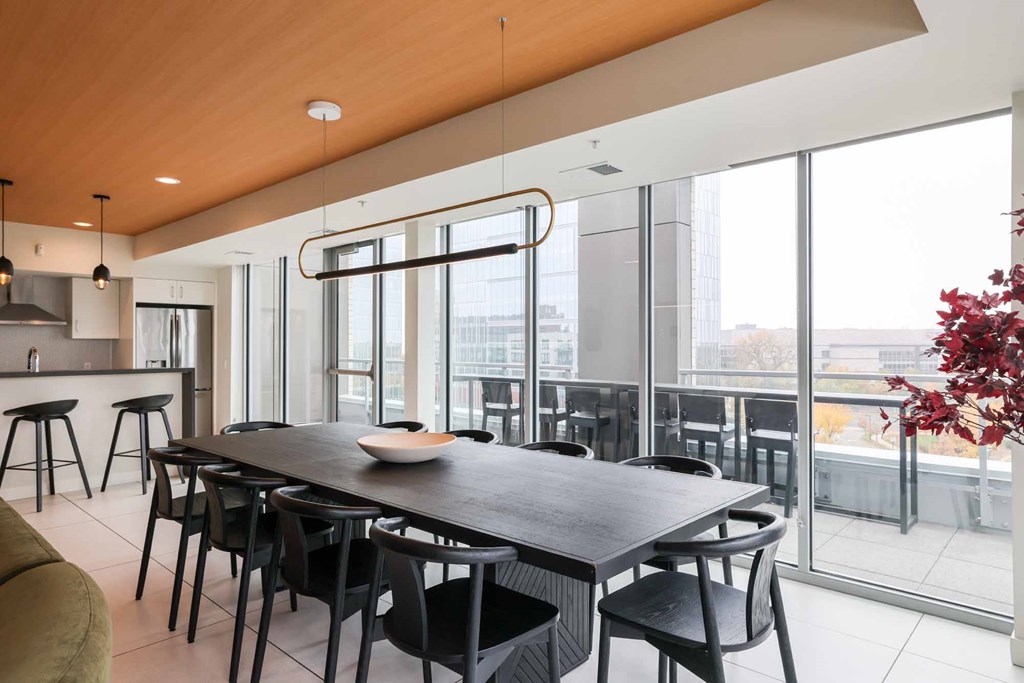 A modern dining room with a large table and chairs.