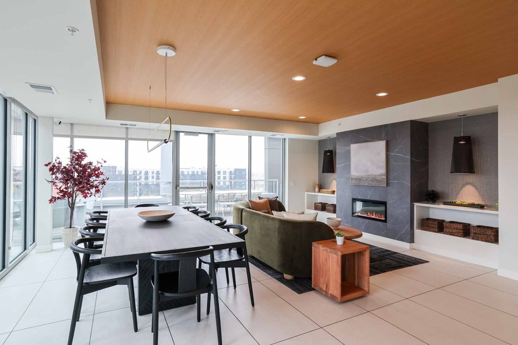 A modern dining room with a wooden table and chairs.