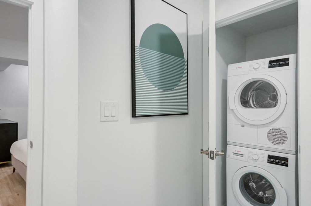 a white washer and dryer in a room with a door