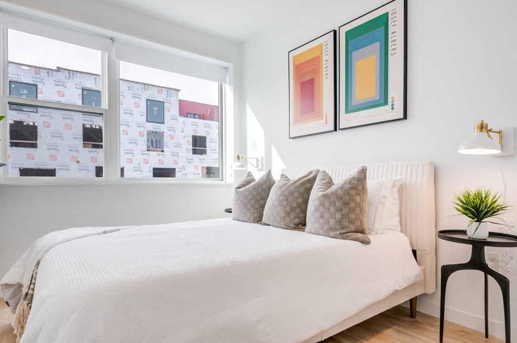 a bedroom with a large bed and a window