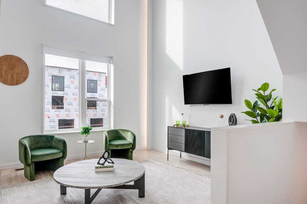 a living room with a table and chairs and a television