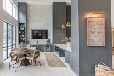 A modern kitchen with a dining table and chairs.