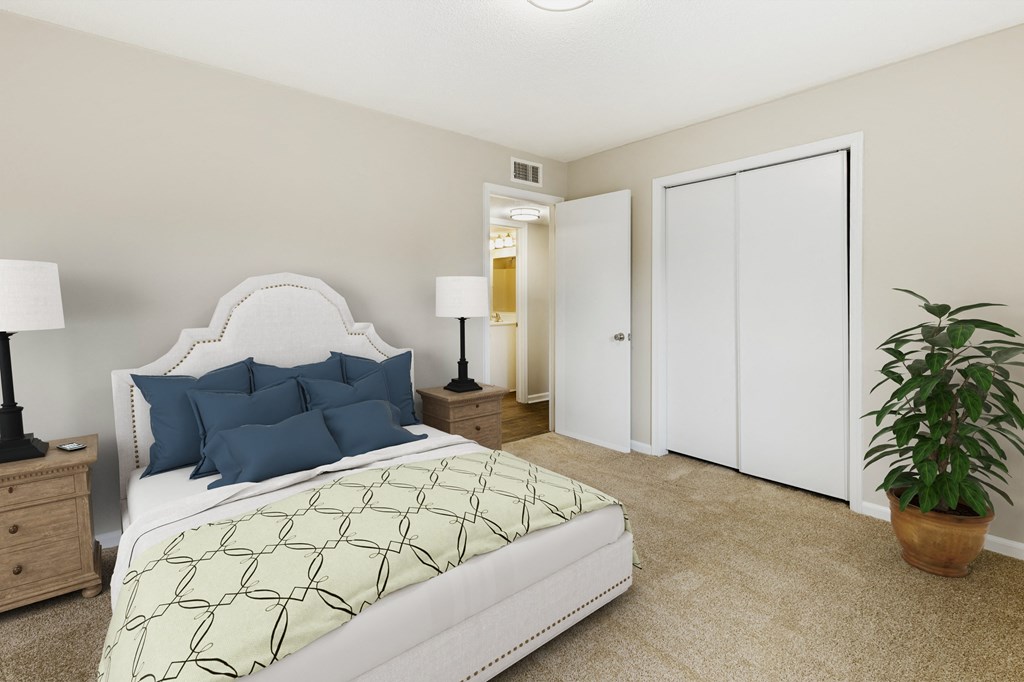 a bedroom with a large bed and a potted plant