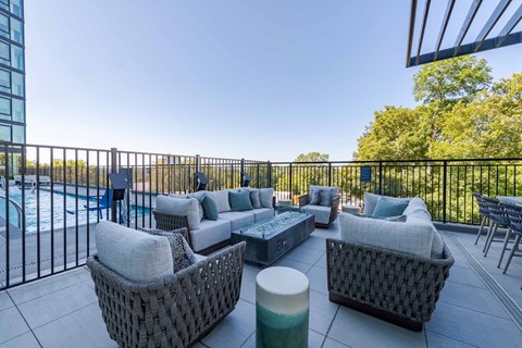 A patio with a pool and a black fence.