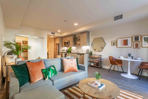 A living room with a grey couch and a wooden coffee table.