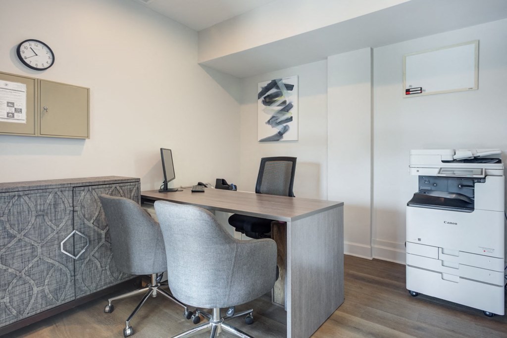 a home office with a desk and two chairs