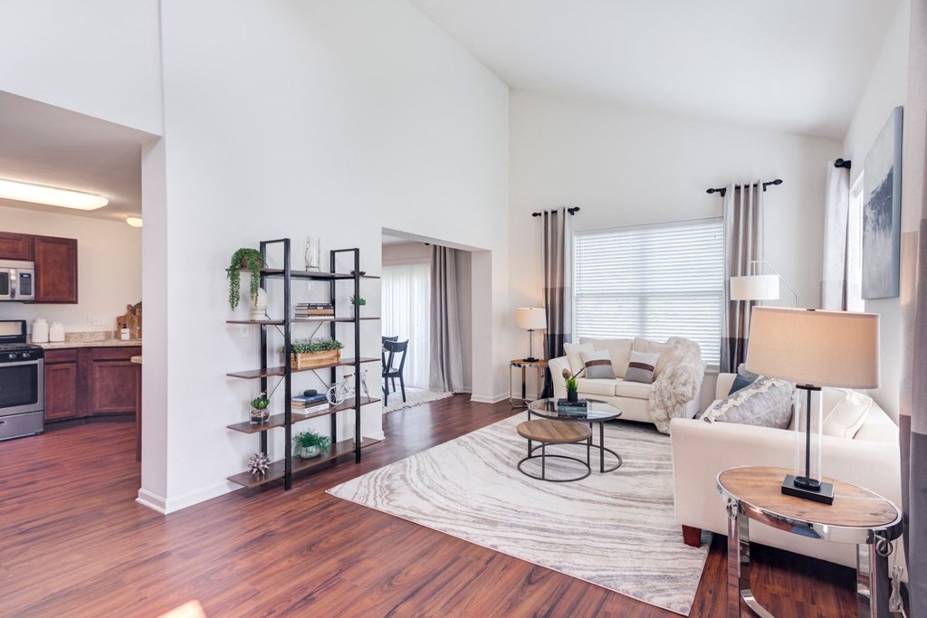 a living room with hardwood floors and white walls