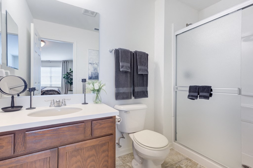 a bathroom with a toilet sink and shower