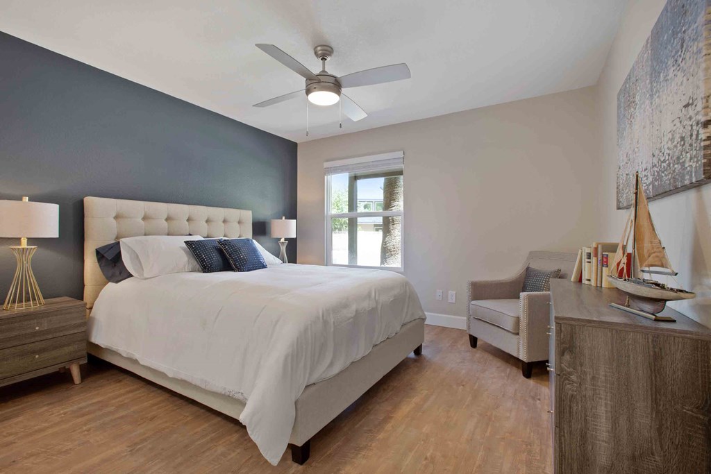 a bedroom with a bed and a ceiling fan