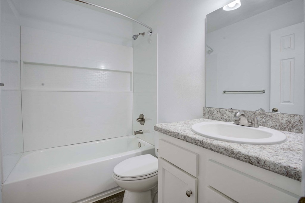 Bathroom with tub, shower, and large mirror at The Marley at Trout River in Jacksonville, Florida.