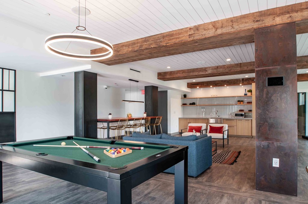 a pool table in the center of a living room