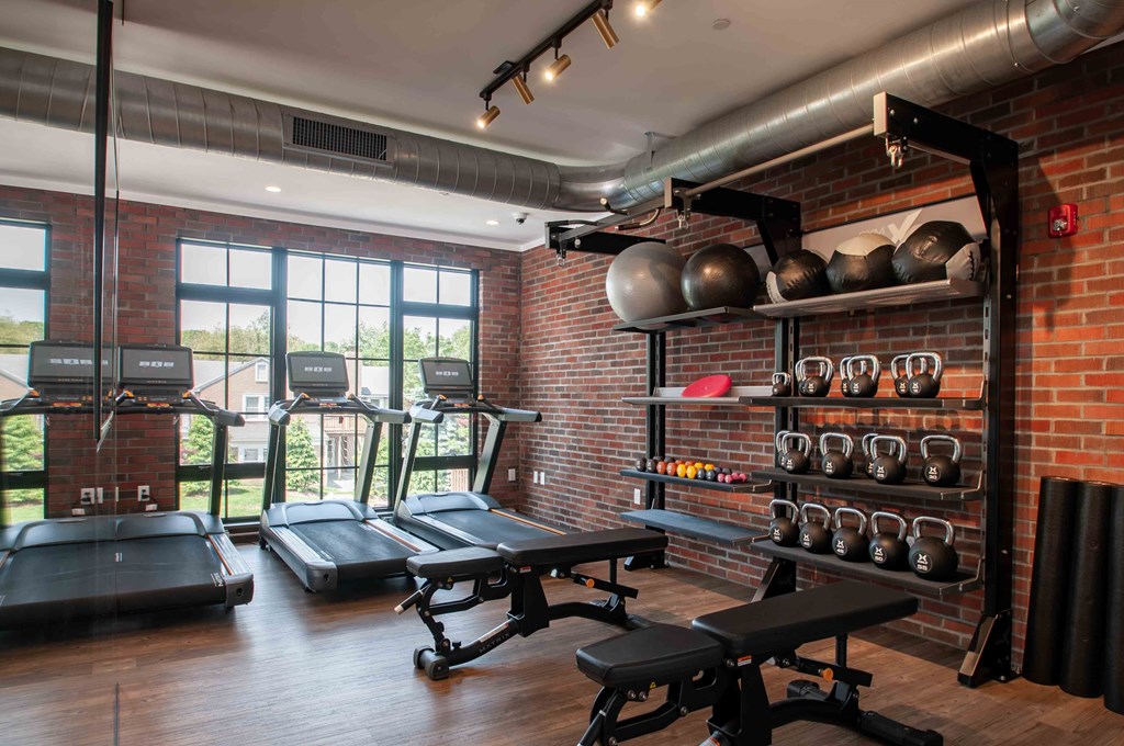 a gym with brick walls and a large window
