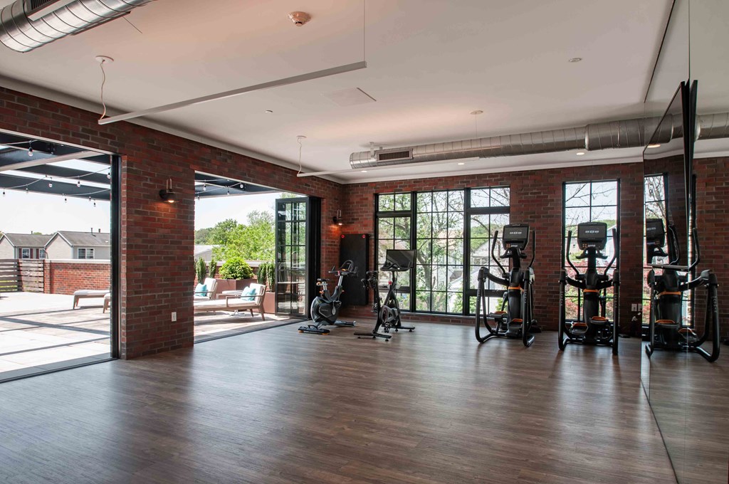 a workout room with weights and a large window
