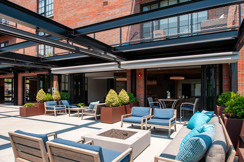 a patio with furniture and tables outside of a building
