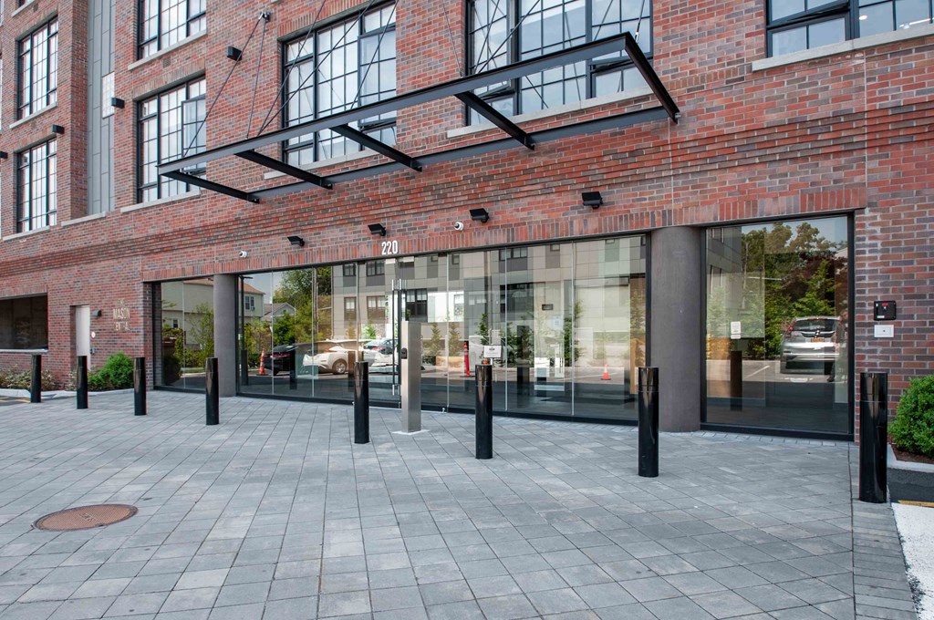 the entrance to a brick building with glass doors