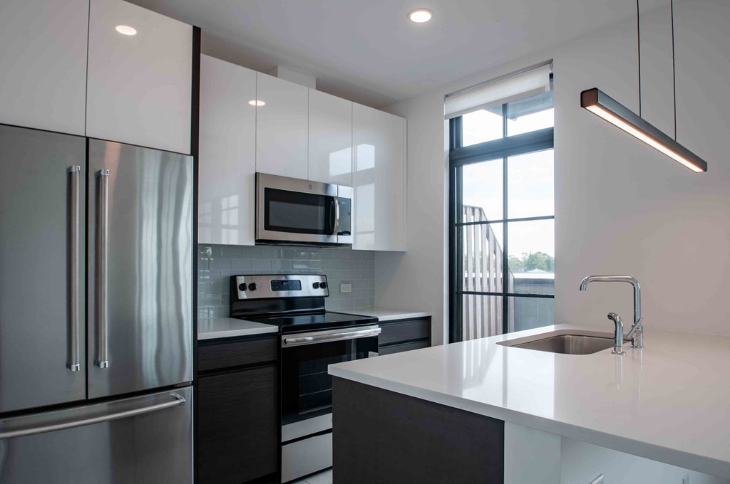 a kitchen with a sink and a refrigerator